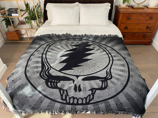 Black & White Steal Your Face blanket on a bed