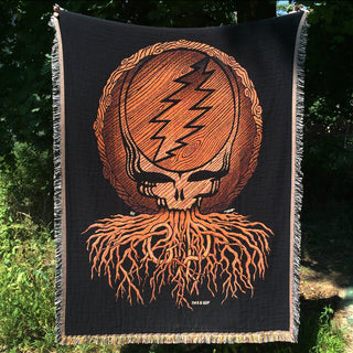 The Grateful Dead Roots Stealie blanket being held up for display outside
