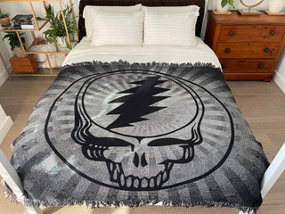 Black & White Steal Your Face blanket on a bed