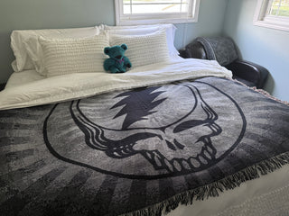 Black & White Steal Your Face blanket on a bed