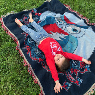 Grateful Dead Dancing Bear Face Toddler Hoodie red variant on child stretching on blanket
